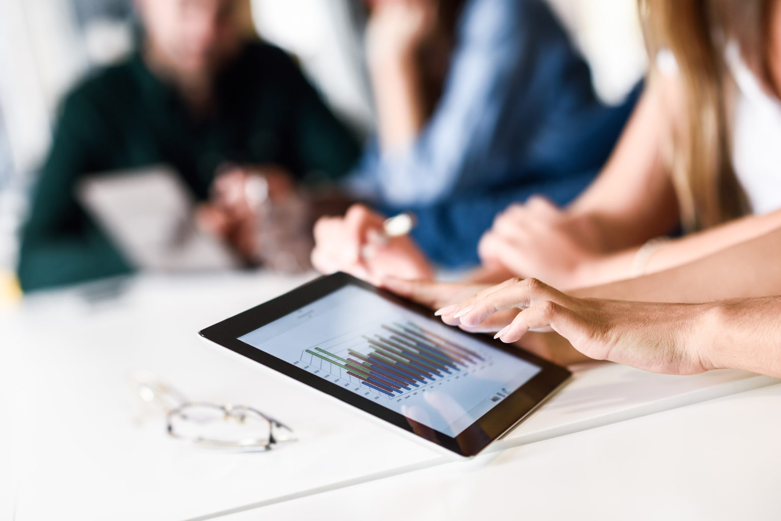 Group of young men and woman coworking with tablet computer