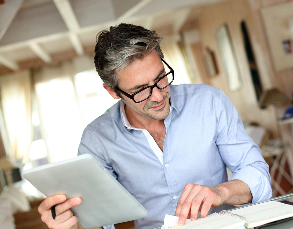 Handsome businessman with eyeglasses working from home