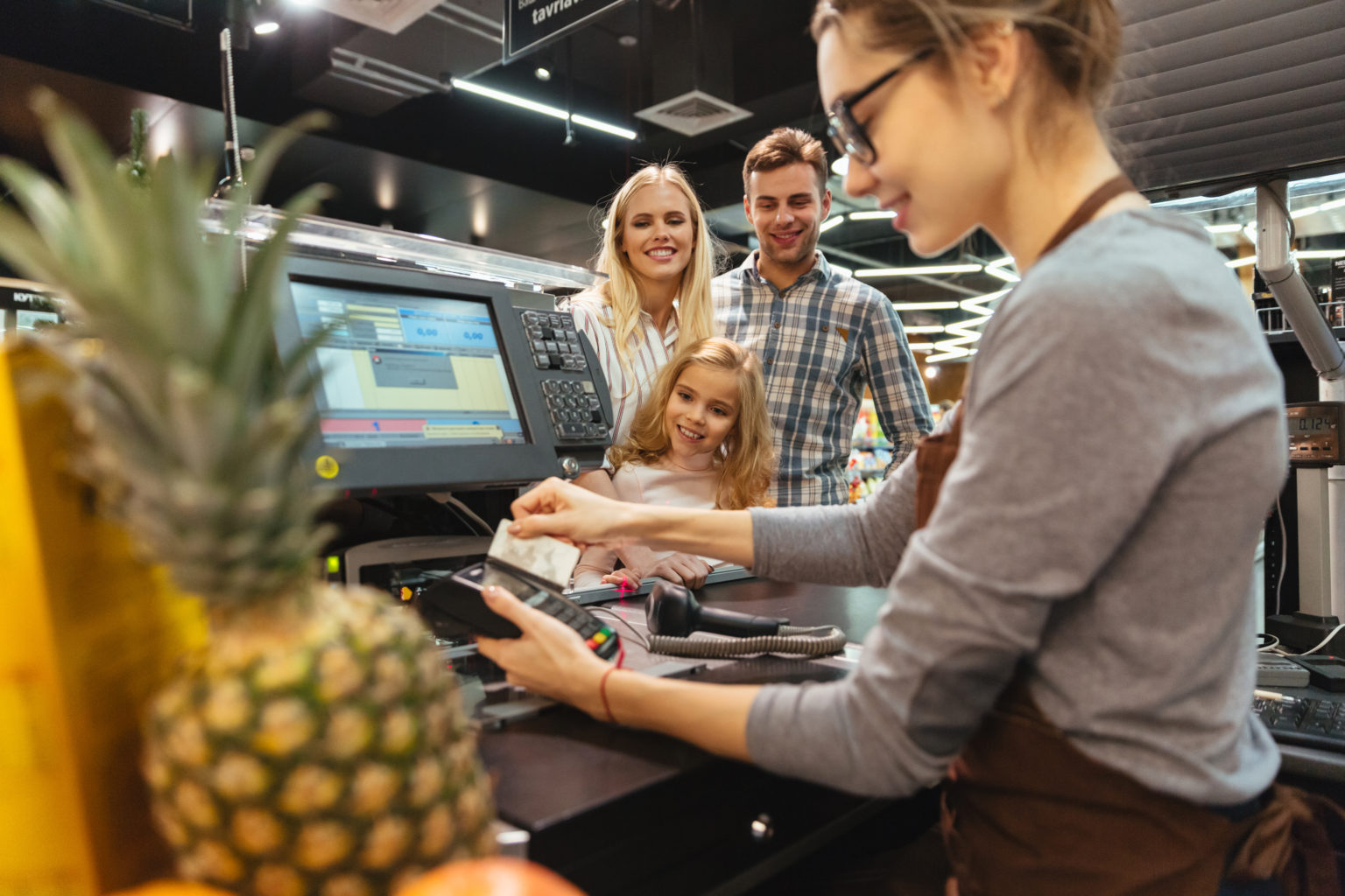 Smiling family paying with a credit card